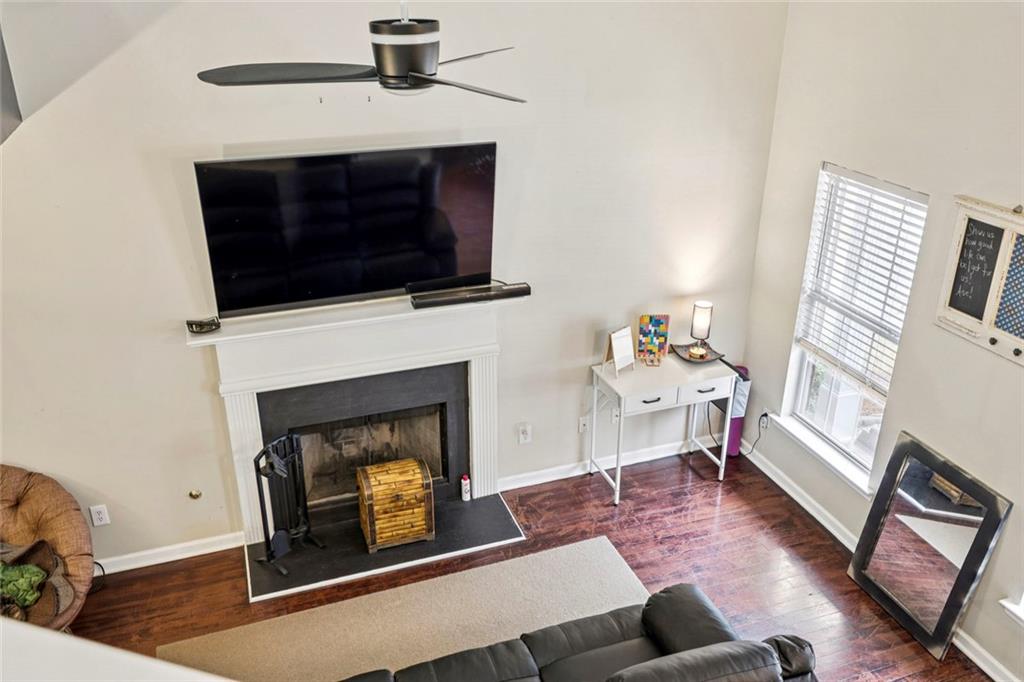 1257 Gates Circle Southeast Atlanta, GA 30316 - Photo 6 of 26 a living room with furniture a fireplace and a flat screen tv