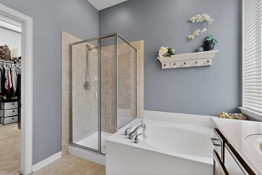 4004 White Porch Road Plano, TX 75024 - Photo 25 of 40 a bathroom with a bathtub and a shower
