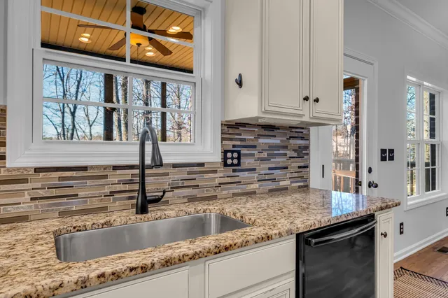 a kitchen with granite countertop a sink and a window