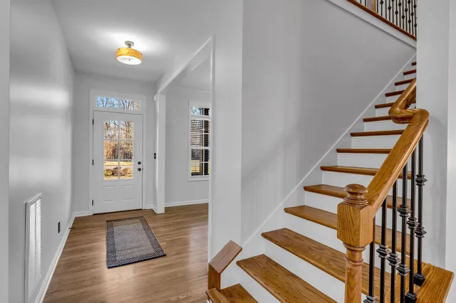 a view of entryway and hall with wooden floor