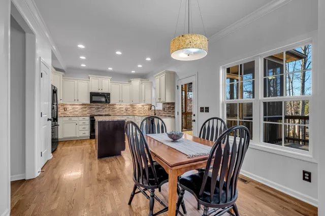 a view of a dining room with furniture large window and wooden floor