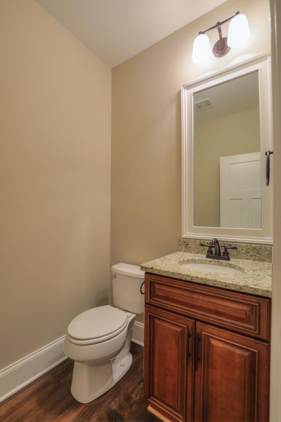 2219 Cairo Bend Road Lebanon, TN 37087 - Photo 11 of 30 a bathroom with a granite countertop toilet sink mirror and vanity