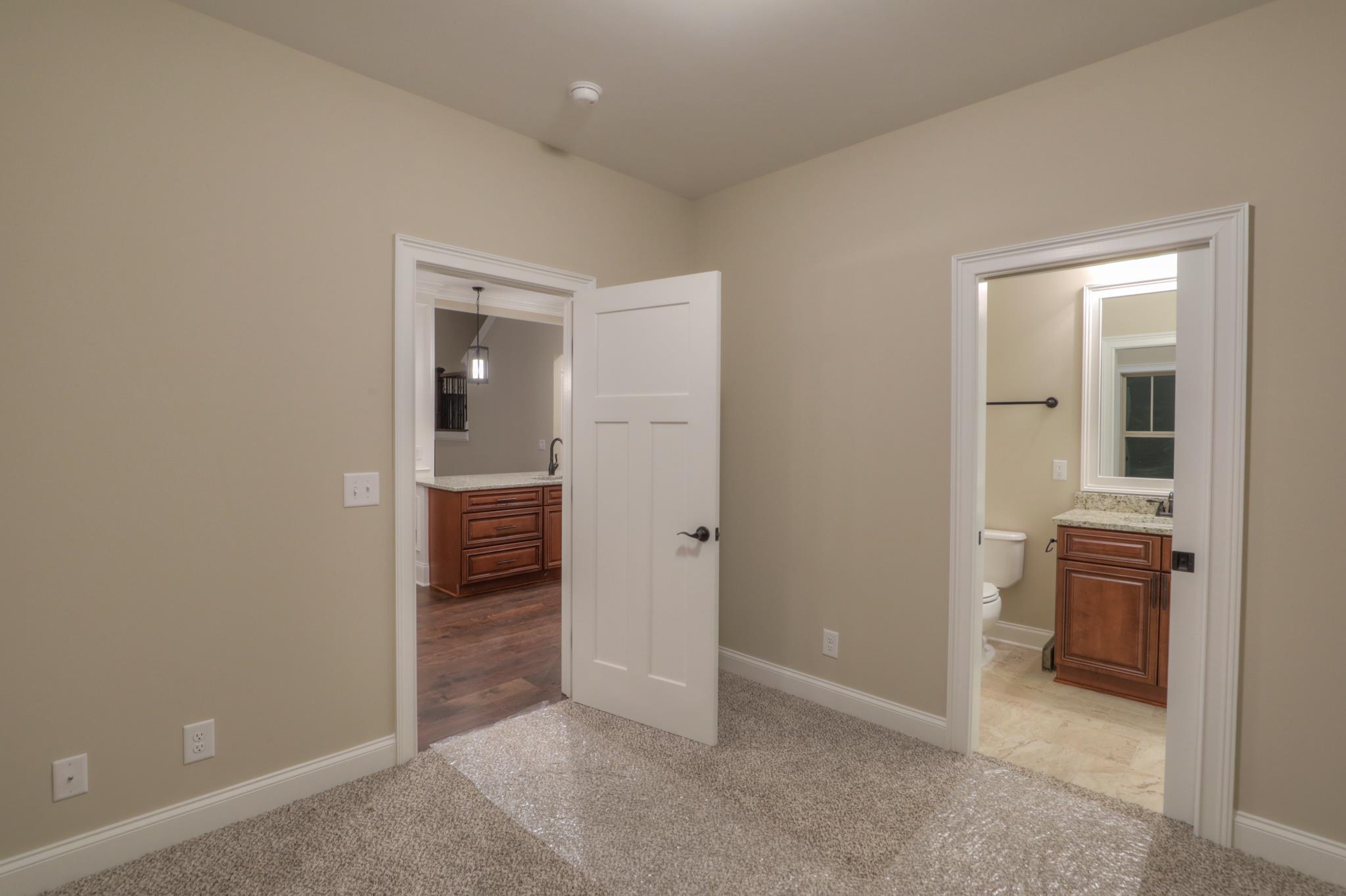 2219 Cairo Bend Road Lebanon, TN 37087 - Photo 23 of 30 an empty room with kitchen view and wooden floor