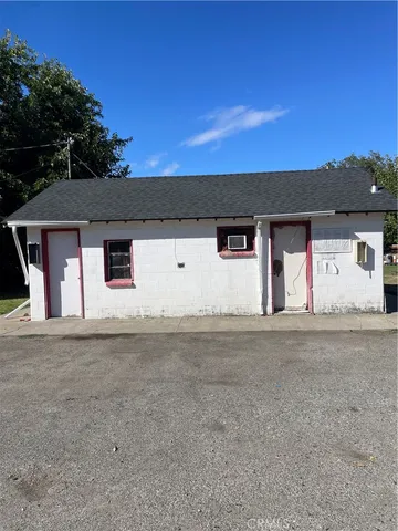 a front view of a house with a road
