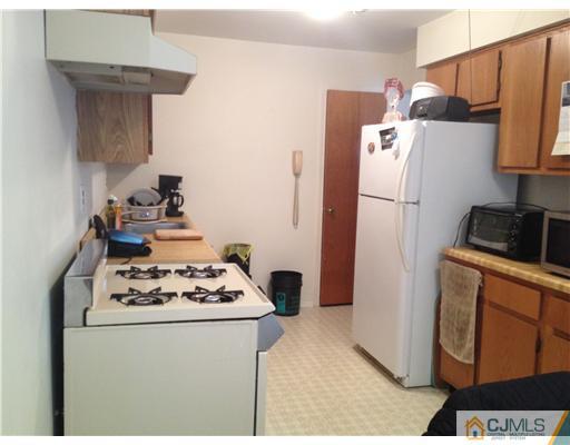 1713 Raspberry Court Edison, NJ 08817 - Photo 2 of 14 a white refrigerator freezer sitting inside of a kitchen