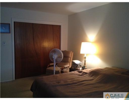 1713 Raspberry Court Edison, NJ 08817 - Photo 6 of 14 a bedroom with a bed and lamps