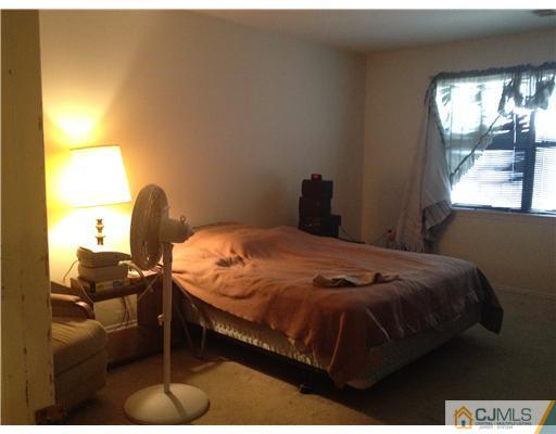 1713 Raspberry Court Edison, NJ 08817 - Photo 8 of 14 a bed sitting in a bedroom next to a window