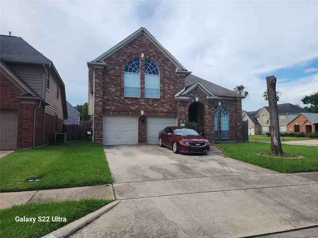 a view of a car parked in front of a brick house