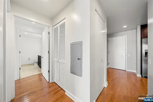 a view of a hallway with wooden floor