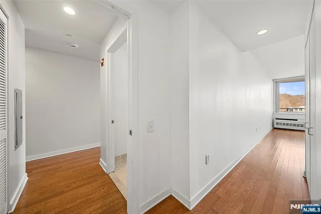 a view of a room with wooden floor
