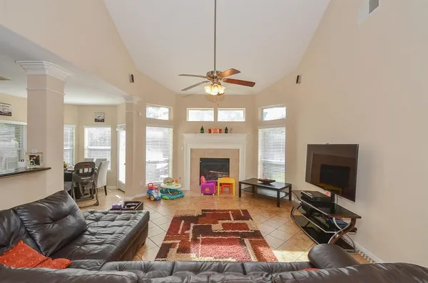 a living room with furniture a fireplace and a flat screen tv