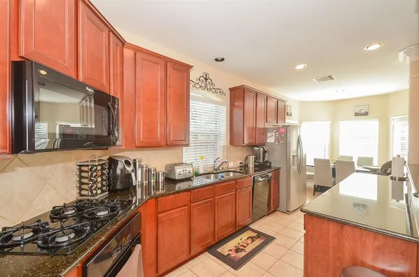 a kitchen with stainless steel appliances a sink stove and cabinets