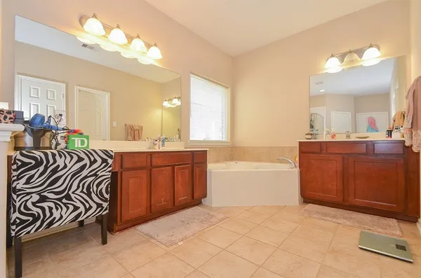 a spacious bathroom with a sink a mirror and a bathtub
