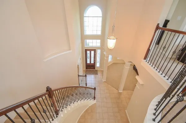 a view of stairs and hall with wooden floor