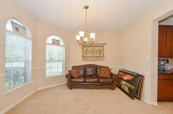 a living room with furniture and a chandelier