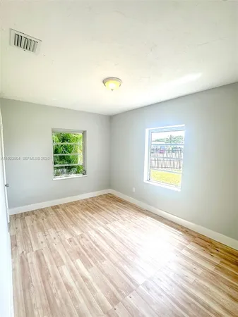 a view of an empty room and a window