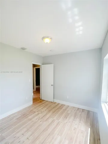 a view of an empty room and wooden floor