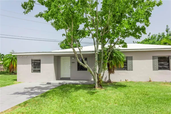 a house that has a tree in front of the house