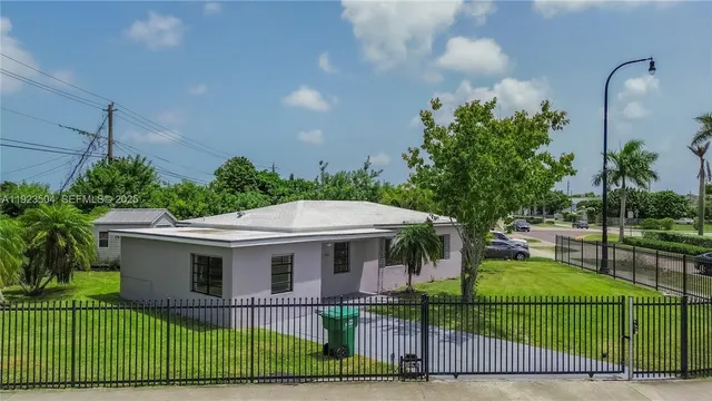 a view of a house with a backyard and a patio