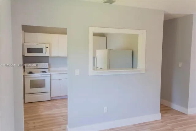a view of kitchen with sink oven and cabinets
