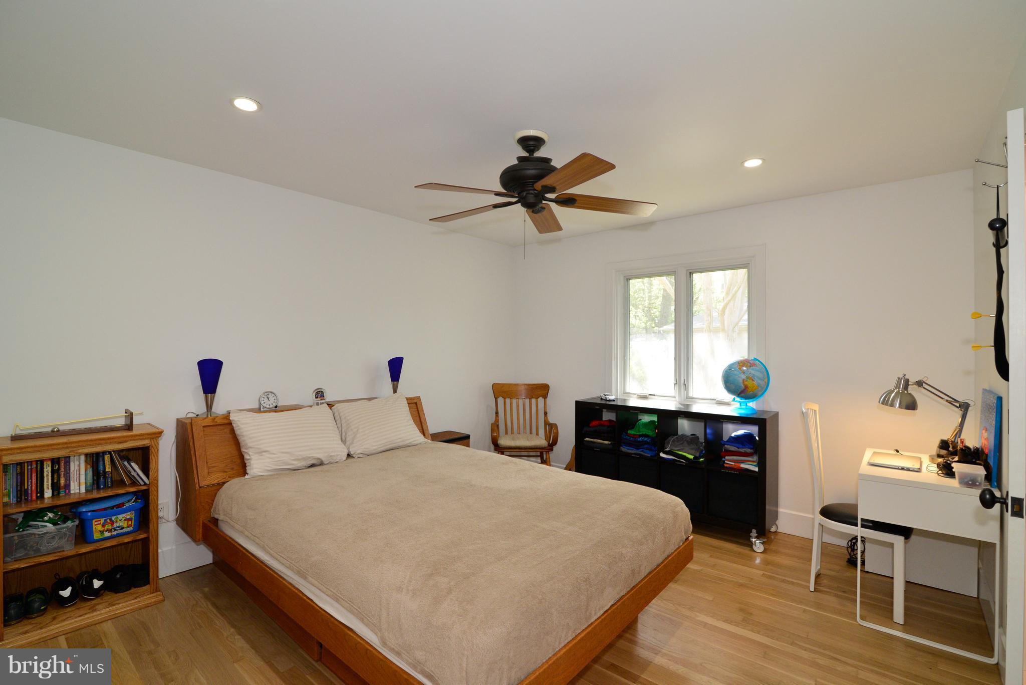 11316 South Shore Road Reston, VA 20190 - Photo 17 of 29 a bedroom with a bed and a chandelier