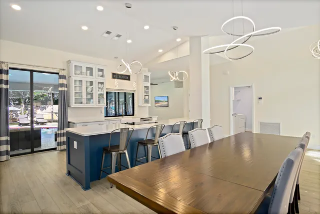 a dining room with stainless steel appliances furniture a window and kitchen view