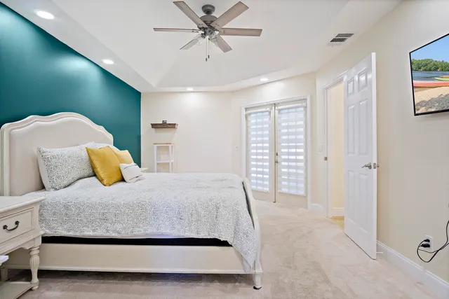 a bedroom with a large bed and a chandelier