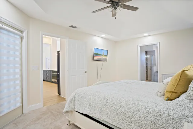 a bedroom with a bed and a ceiling fan