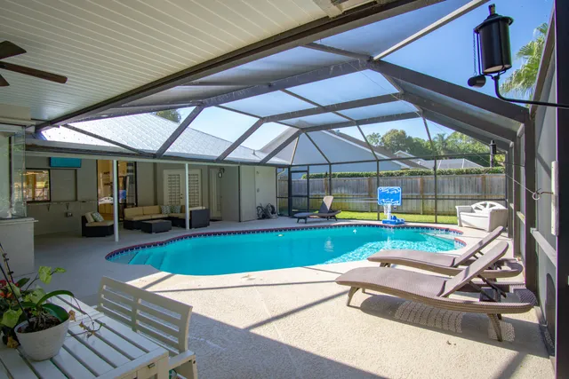 a view of a backyard with sitting area