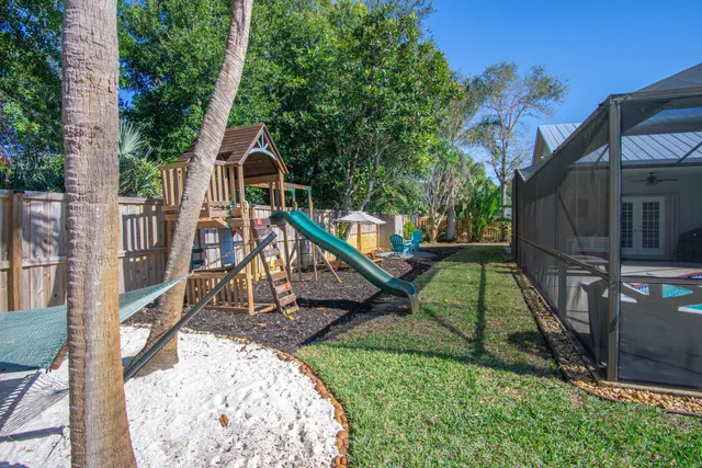 a front view of a house with a yard and potted plants