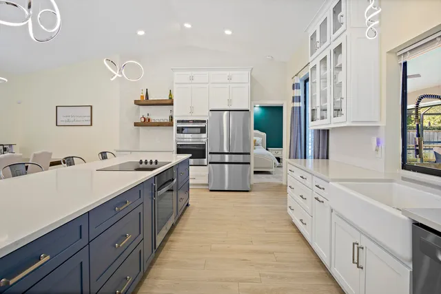 a large kitchen with stainless steel appliances sink a microwave and cabinets