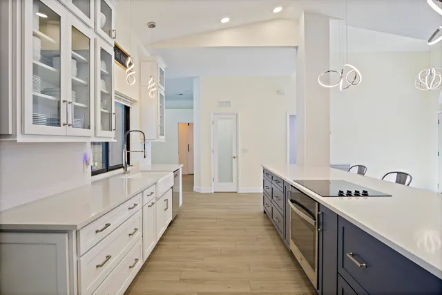 a large white kitchen with a large sink