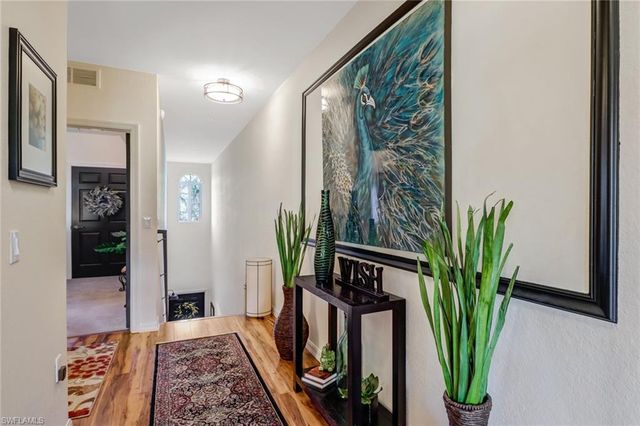 a view of a living room with furniture and a potted plant