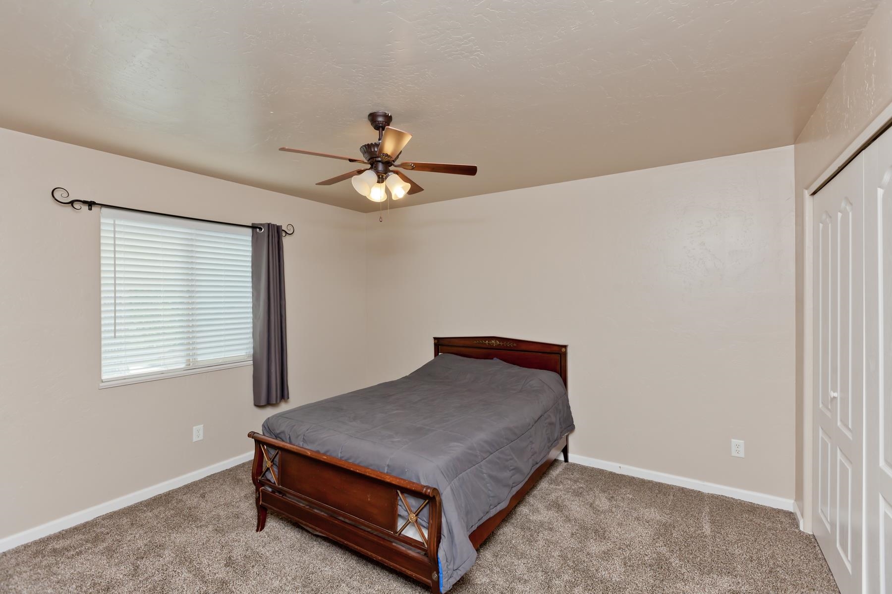 718 Sabil Drive Fruita, CO 81521 - Photo 18 of 35 a living room with a bed furniture and a window