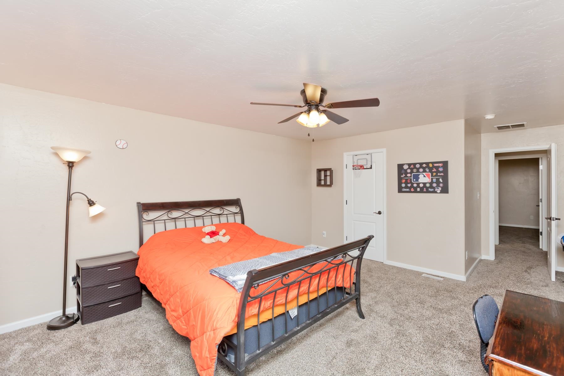 718 Sabil Drive Fruita, CO 81521 - Photo 24 of 35 a bedroom with a bed and a chandelier