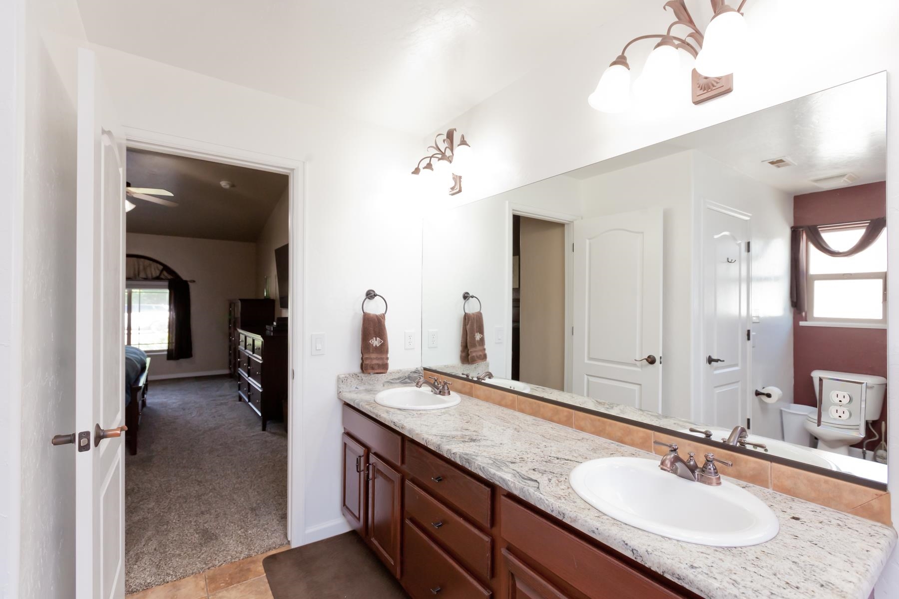 718 Sabil Drive Fruita, CO 81521 - Photo 26 of 35 a en suite bathroom with a granite countertop sink and a mirror
