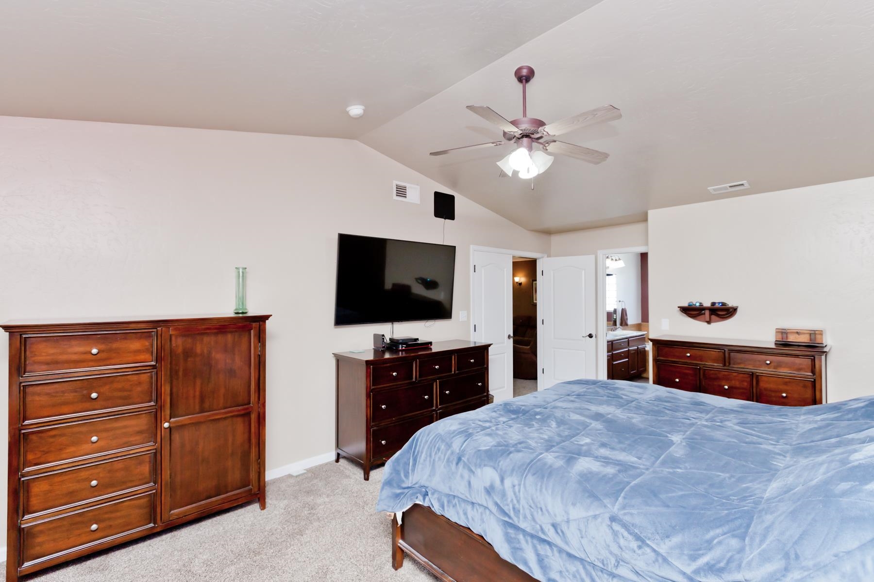 718 Sabil Drive Fruita, CO 81521 - Photo 27 of 35 a bedroom with a bed and a flat screen tv
