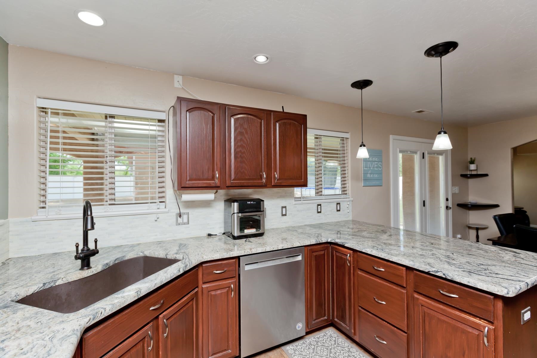 718 Sabil Drive Fruita, CO 81521 - Photo 3 of 35 a kitchen with granite countertop a sink and a wooden cabinets
