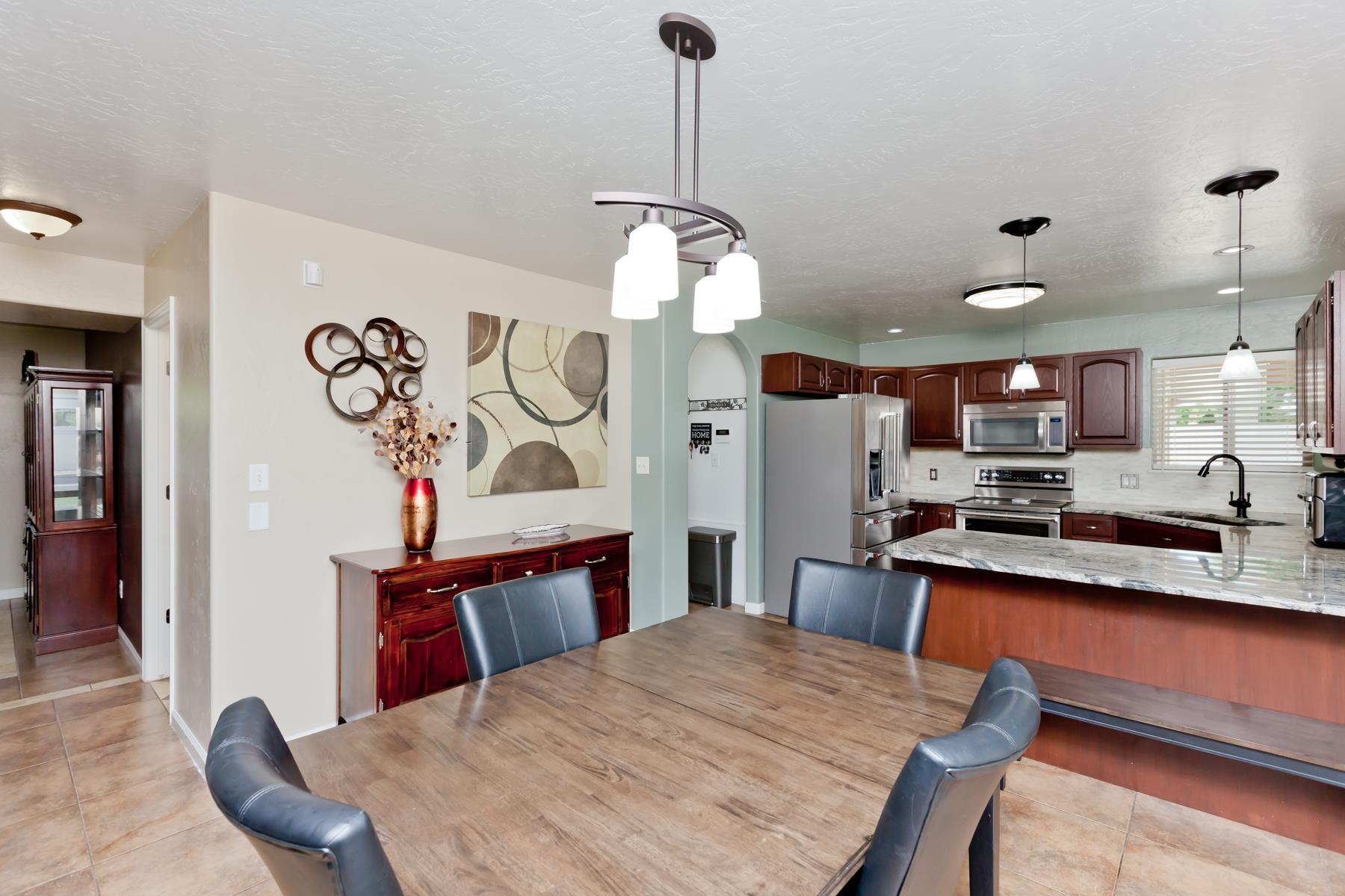 718 Sabil Drive Fruita, CO 81521 - Photo 7 of 35 a kitchen with stainless steel appliances kitchen island a dining table and chairs