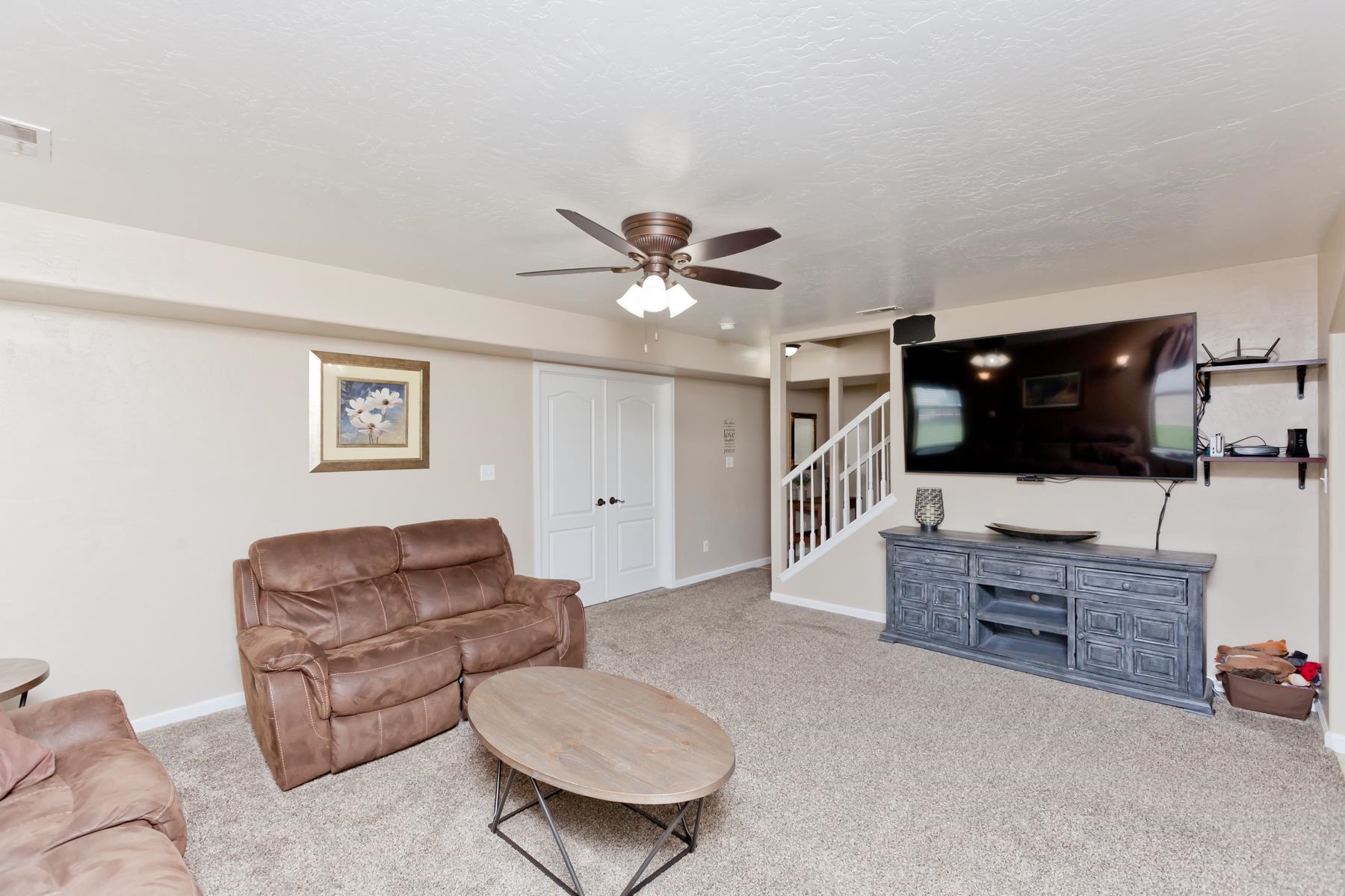 718 Sabil Drive Fruita, CO 81521 - Photo 10 of 35 a living room with furniture and a flat screen tv
