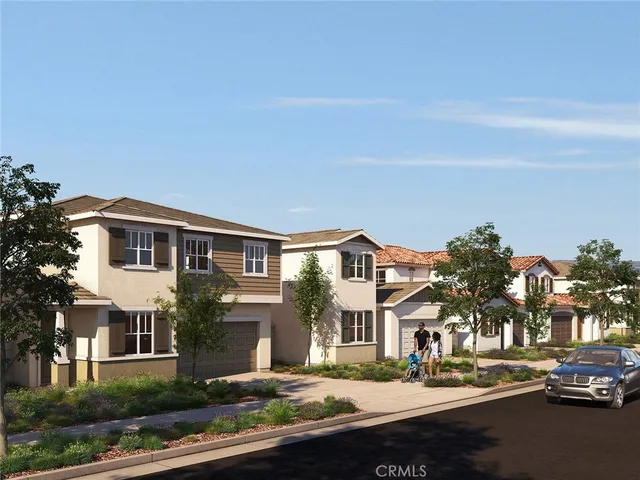 a front view of a residential apartment building with a yard