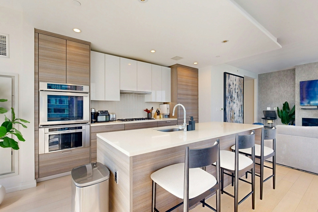 1 Franklin Street, Unit 2308 Boston, MA 02110 - Photo 12 of 41 a kitchen with a stove a sink and a refrigerator
