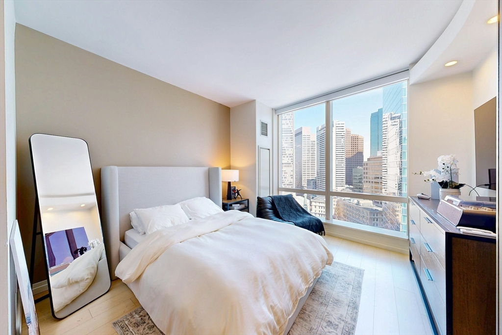 1 Franklin Street, Unit 2308 Boston, MA 02110 - Photo 15 of 41 a bedroom with a large bed and a large window