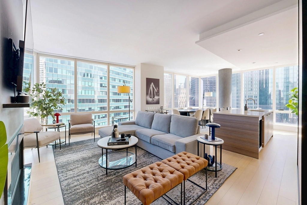 1 Franklin Street, Unit 2308 Boston, MA 02110 - Photo 2 of 41 a living room with furniture and a large window