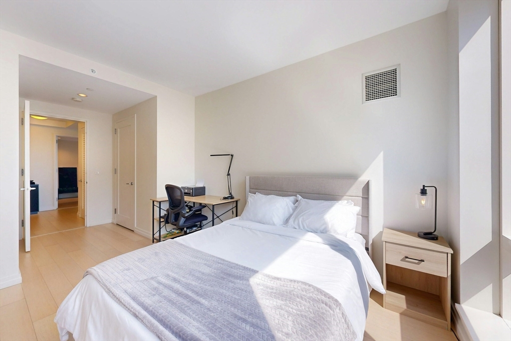 1 Franklin Street, Unit 2308 Boston, MA 02110 - Photo 23 of 41 a bedroom with a bed and wooden floor