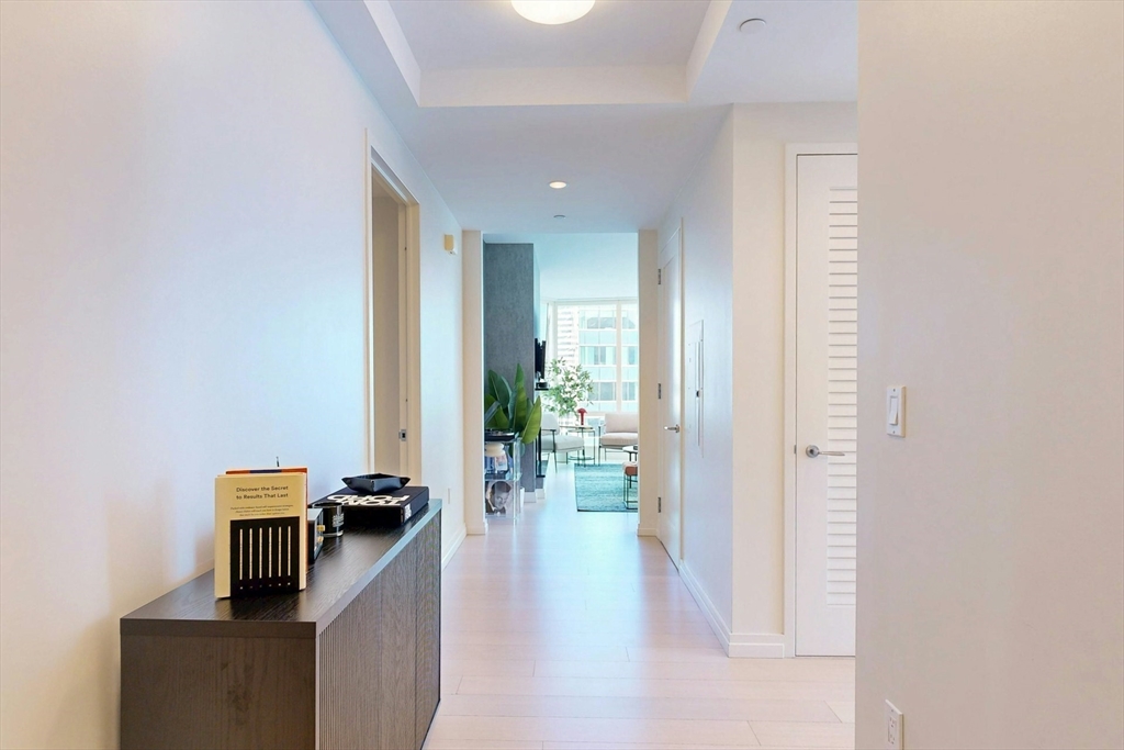 1 Franklin Street, Unit 2308 Boston, MA 02110 - Photo 27 of 41 a view of a hallway with workspace and living room