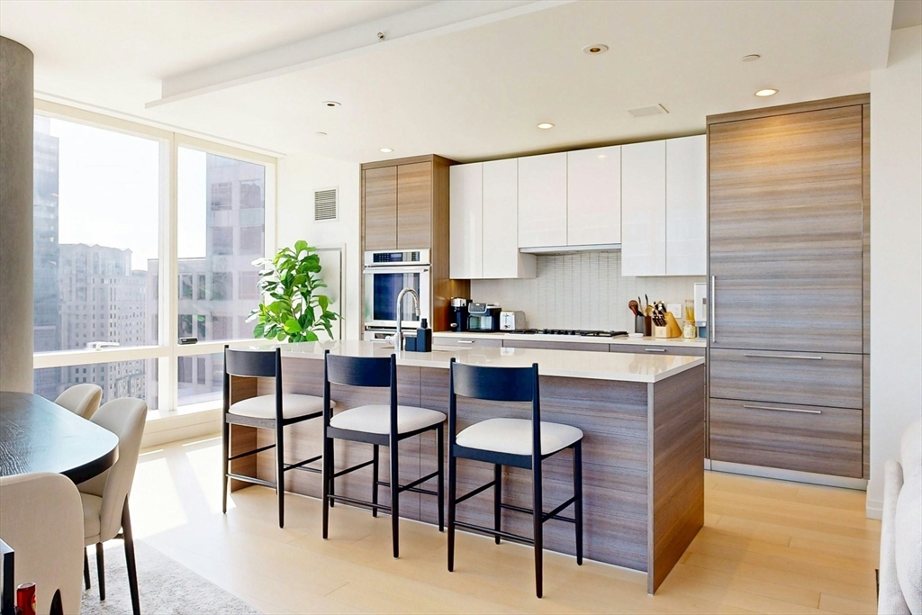 1 Franklin Street, Unit 2308 Boston, MA 02110 - Photo 9 of 41 a kitchen with a table chairs and a window