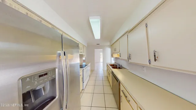 a kitchen with stainless steel appliances a refrigerator and a stove