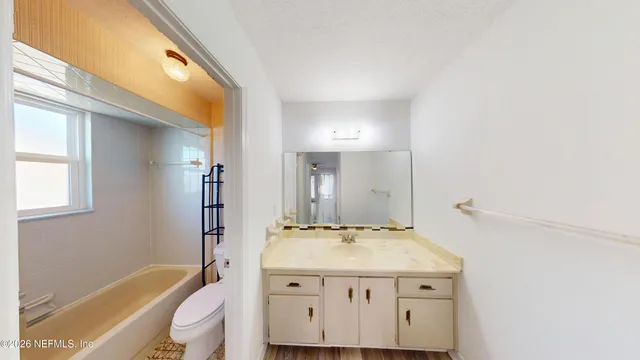 a bathroom with a sink a mirror and a bathtub