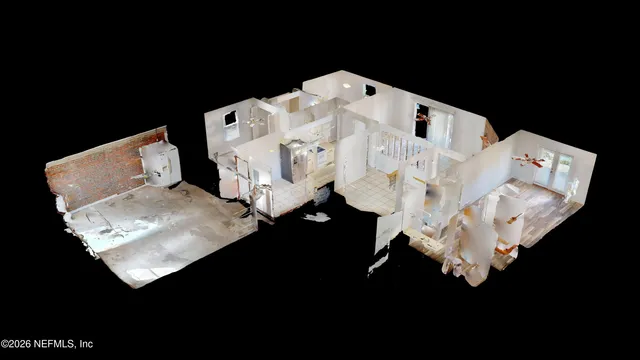 a large white bed sitting in a bedroom next to a white wall